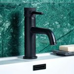 Matte Black Monobloc Basin Tap With a green tiled background and a white gloss ceramic basin with a square matte black overflow cover