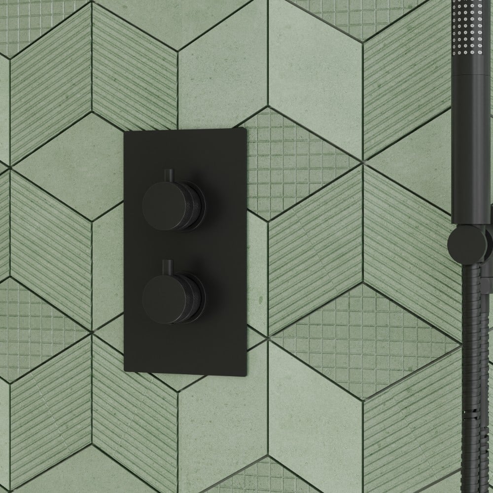 a core matt black thermostatic concealed shower valve with a green tile background