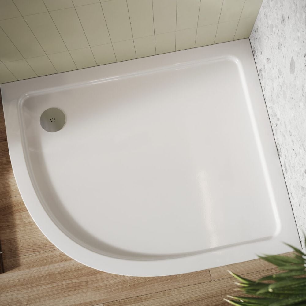 a shires offset quadrant shower tray with a chrome shower waste