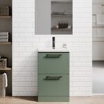 Blake Reed Green Twin Drawer 500mm Floor Standing Vanity Unit With Matte Black knurled handles against a white wall & a oak finish floor with a rectangle plain mirror above.